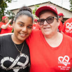 Two women at a community event, smiling together.