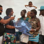 Group with microphone and electric fan outside