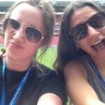 Two women taking a selfie in a stadium.