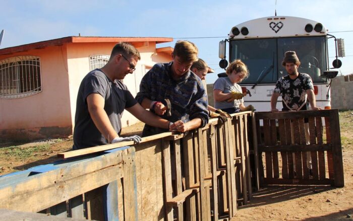 Volunteers building a wooden structure.