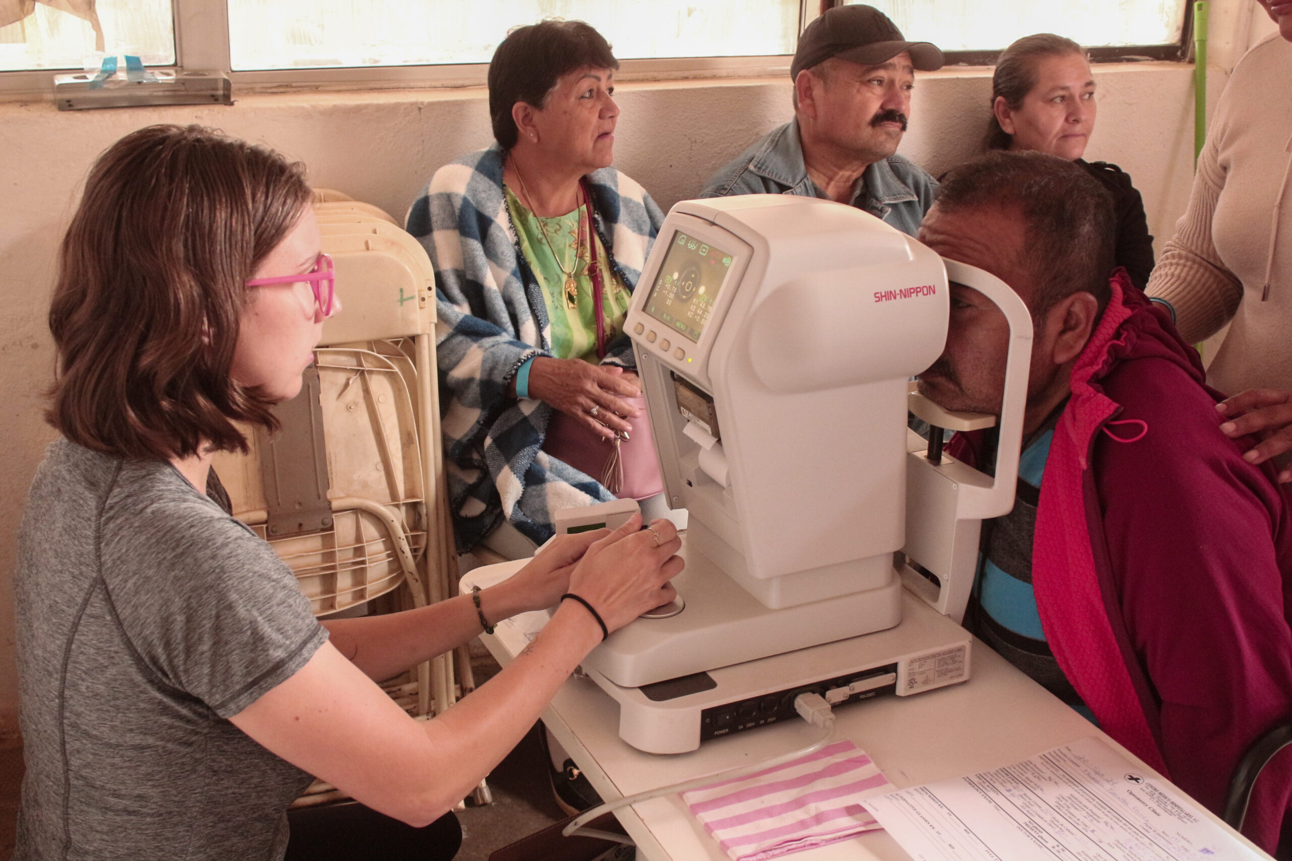 Eye examination using ophthalmic equipment in clinic.