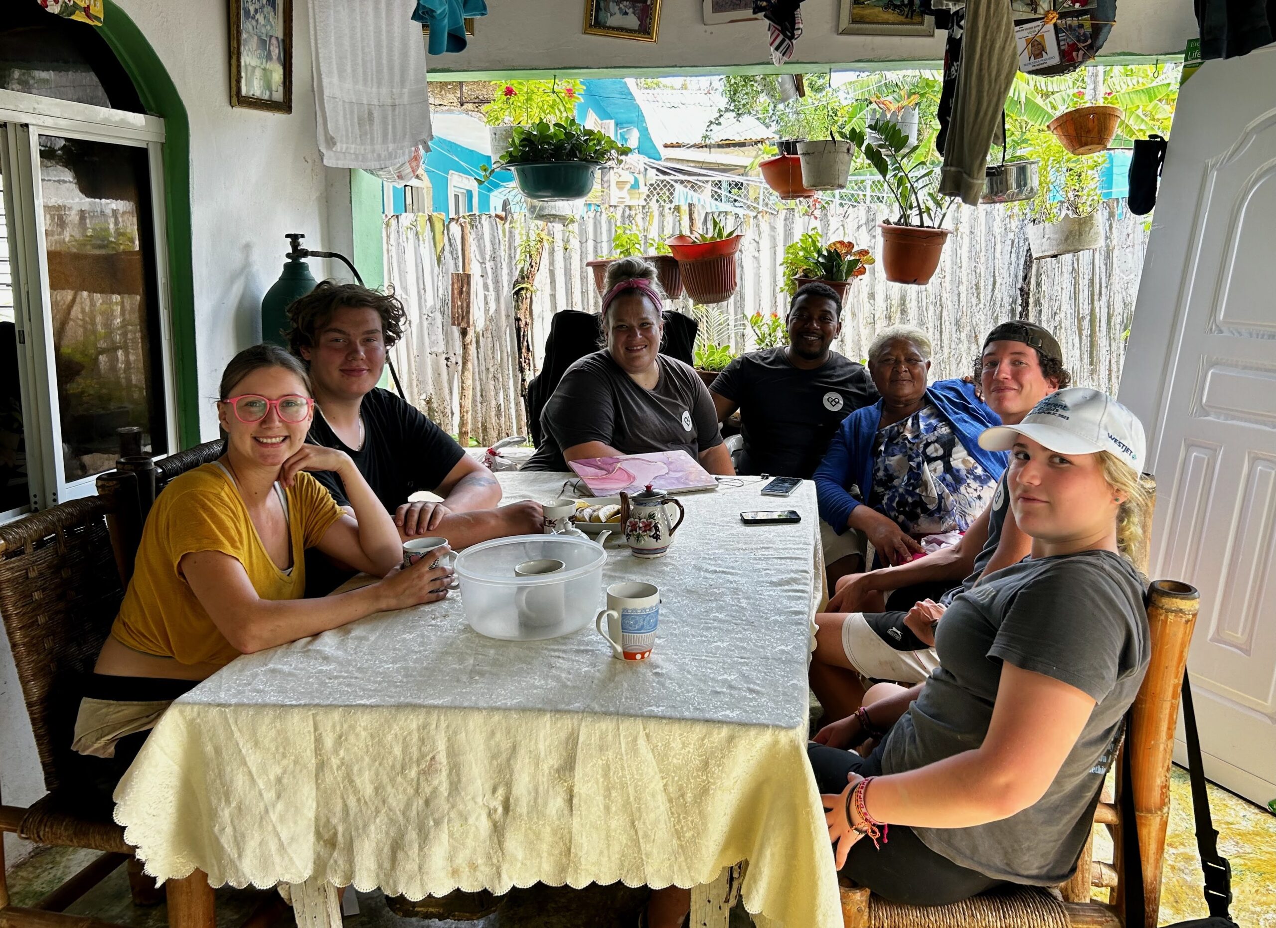 Group gathered around a table in a bright room.