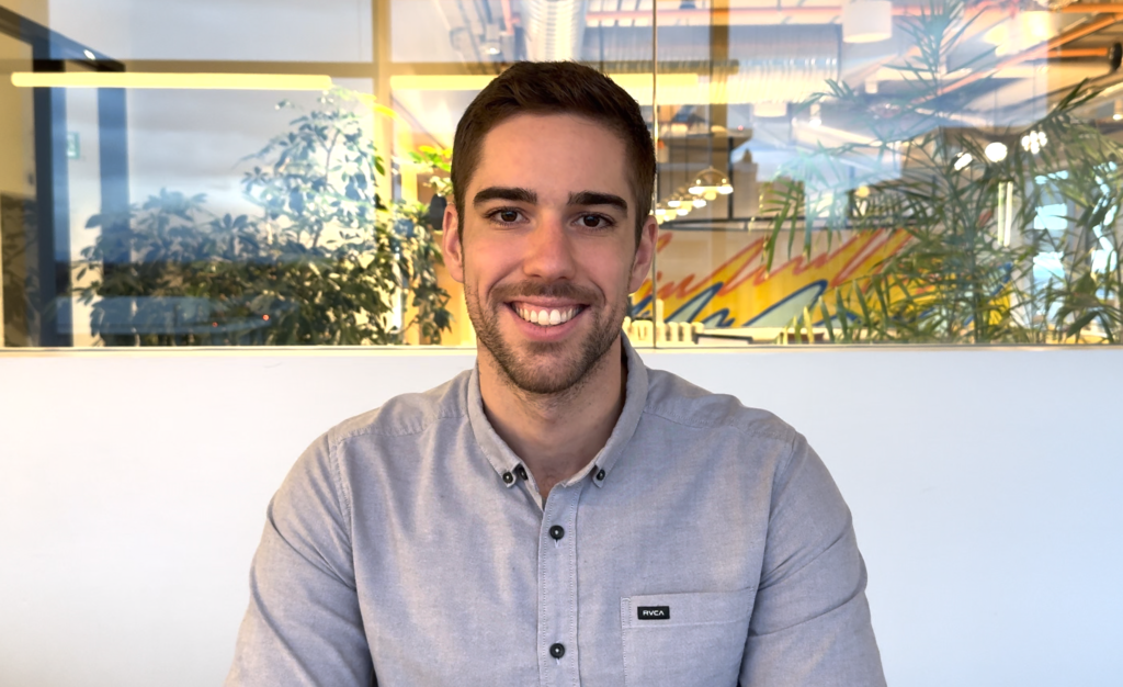 Smiling person at a modern office workspace.