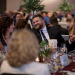 People enjoying conversation at formal event.
