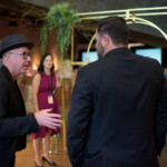 People conversing at a formal event.