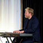 Man playing keyboard on stage